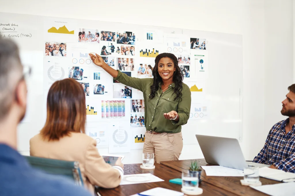 Instructor presenting team-based project results and analytics, showcasing a structured PMP-style training setup.